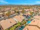 An aerial shot pinpoints the home within a vast neighborhood with the city skyline and mountains in the background at 2766 Chokecherry Ave, Henderson, NV 89074