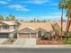 Inviting single-story home featuring a tile roof, two car garage, and desert landscaping at 2766 Chokecherry Ave, Henderson, NV 89074
