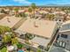 An aerial view of the home, showcasing the roof, patio, in-ground pool, and mature landscaping in a neighborhood setting at 2766 Chokecherry Ave, Henderson, NV 89074