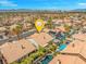 An aerial shot pinpoints the home within a vast neighborhood with the city skyline and mountains in the background at 2766 Chokecherry Ave, Henderson, NV 89074