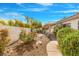 Landscaped backyard featuring a covered patio, mature shrubs, and rock features offering a relaxing retreat at 2766 Chokecherry Ave, Henderson, NV 89074