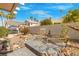 Landscaped backyard featuring lounge chairs, brick pavers, and privacy walls at 2766 Chokecherry Ave, Henderson, NV 89074