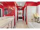 Bathroom with a red wall, double mirrors, walk in shower and decor at 2766 Chokecherry Ave, Henderson, NV 89074