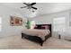 Bright bedroom featuring a ceiling fan, neutral carpet, large windows with a comfortable king size bed at 2766 Chokecherry Ave, Henderson, NV 89074