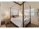 Bedroom featuring a four-poster bed, neutral walls, and a window for natural light at 2766 Chokecherry Ave, Henderson, NV 89074