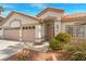Inviting home exterior featuring a two-car garage and manicured landscaping at 2766 Chokecherry Ave, Henderson, NV 89074