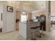 Bright kitchen featuring a granite countertop island with bar stool seating and stainless steel appliances at 2766 Chokecherry Ave, Henderson, NV 89074