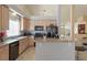 Charming kitchen featuring granite countertops, wood cabinets, stainless steel appliances, and a breakfast bar at 2766 Chokecherry Ave, Henderson, NV 89074