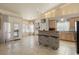 Open concept kitchen with breakfast bar, bright natural light, tile flooring and access to backyard patio at 2766 Chokecherry Ave, Henderson, NV 89074