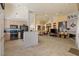 Open floor plan with kitchen, living room, tile flooring, and a cozy fireplace, great for entertaining at 2766 Chokecherry Ave, Henderson, NV 89074