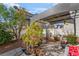 Shaded backyard patio featuring mature plants and a seating area, ideal for outdoor gatherings and relaxation at 2851 Glistening Grove Ave, Henderson, NV 89052