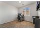 Neutral-toned bedroom, showing a desk and chair setup and a window for light, perfect for an office space at 2851 Glistening Grove Ave, Henderson, NV 89052