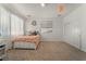 Inviting bedroom featuring neutral carpet, white walls, closet, and a cozy bed with decorative wreath at 2851 Glistening Grove Ave, Henderson, NV 89052