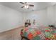 Spacious bedroom featuring a ceiling fan, carpeted floors, and a vanity with natural light and fresh air at 2851 Glistening Grove Ave, Henderson, NV 89052