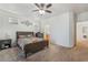 Cozy bedroom featuring a ceiling fan, carpeted floors, and a comfortable bed with a colorful comforter at 2851 Glistening Grove Ave, Henderson, NV 89052