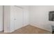 Neutral-toned bedroom with carpet, a blank wall and double doors perfect for closets or additional storage at 2851 Glistening Grove Ave, Henderson, NV 89052