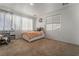 Bright bedroom with plush carpet, large window, and a charming white bed frame with storage drawers at 2851 Glistening Grove Ave, Henderson, NV 89052