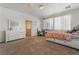 Spacious bedroom with carpet, featuring a bed with storage, dresser, and a separate desk area at 2851 Glistening Grove Ave, Henderson, NV 89052