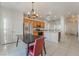 Bright kitchen featuring stainless steel appliances, wooden cabinetry, and a breakfast bar open to the dining area at 2851 Glistening Grove Ave, Henderson, NV 89052