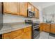 A well-equipped kitchen boasting stainless steel appliances and warm wood cabinets at 2851 Glistening Grove Ave, Henderson, NV 89052