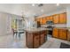 Open kitchen area with wood cabinets, stainless appliances and a large center island at 2851 Glistening Grove Ave, Henderson, NV 89052