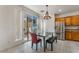 Bright kitchen featuring stainless steel appliances, wooden cabinetry, and sliding glass door access to the backyard at 2851 Glistening Grove Ave, Henderson, NV 89052