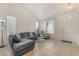 Bright living room with neutral tile flooring, vaulted ceilings and comfortable gray seating at 2851 Glistening Grove Ave, Henderson, NV 89052