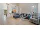 Open-concept living area featuring tile flooring, comfortable seating and view to kitchen at 2851 Glistening Grove Ave, Henderson, NV 89052