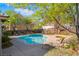 Community pool with lounge chairs and spa surrounded by mature trees at 2851 Glistening Grove Ave, Henderson, NV 89052
