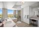 Luxurious bathroom with double sinks, soaking tub, walk-in shower, and scenic city views at 322 Karen Ave # 1507, Las Vegas, NV 89109