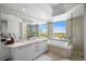 Bright bathroom featuring double sinks, a tub, shower, and city views at 322 Karen Ave # 1507, Las Vegas, NV 89109