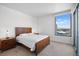 Modern bedroom with a bed, two side tables, and stunning city views from the window at 322 Karen Ave # 1507, Las Vegas, NV 89109