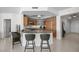 Kitchen island with bar stool seating, granite countertops and stainless appliances open to living areas at 322 Karen Ave # 1507, Las Vegas, NV 89109