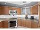 Well-equipped kitchen featuring modern stainless steel appliances, granite countertops and wooden cabinetry at 322 Karen Ave # 1507, Las Vegas, NV 89109