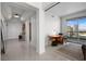 Bright living space with city views, featuring a modern workstation and easy access to the entrance foyer at 322 Karen Ave # 1507, Las Vegas, NV 89109