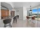 Open living area featuring bar stool seating at kitchen island and dining area with city views at 322 Karen Ave # 1507, Las Vegas, NV 89109