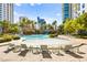 Beautiful resort-style pool with sandy beach area and palm trees surrounded by high-rise buildings at 322 Karen Ave # 1507, Las Vegas, NV 89109