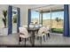 Dining area with stylish table and chairs, large sliding glass doors to backyard and modern blue curtains at 325 Talladega Ct # Lot 6, Henderson, NV 89015