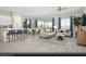 Spacious living room with modern furniture, large windows with blue curtains, and wood-style vinyl plank flooring at 325 Talladega Ct # Lot 6, Henderson, NV 89015