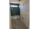 Modern bathroom with stylish blue tiled shower and tiled floors, awaiting finishing touches at 331 Huracan St, Pahrump, NV 89048