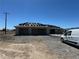 An unfinished house shows a place for the garage and tiles stacked on the roof, awaiting installation at 331 Huracan St, Pahrump, NV 89048