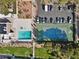 Aerial view of the community pool, spa, tennis court, and parking lot surrounded by landscaping at 3365 Zephyr Ct, Las Vegas, NV 89121