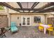 Outdoor patio featuring tan siding, paver stones, seating arrangements, string lights, and a pergola at 3365 Zephyr Ct, Las Vegas, NV 89121