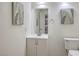 Simple bathroom with vanity, mirror, and decorative wall art at 3365 Zephyr Ct, Las Vegas, NV 89121