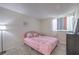 Comfortable bedroom featuring soft carpet, a bright pink bed and a dark dresser for plenty of storage at 3365 Zephyr Ct, Las Vegas, NV 89121