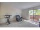 Cozy room with black recliner, exercise equipment, and sliding glass door with a view to the outdoors at 3365 Zephyr Ct, Las Vegas, NV 89121