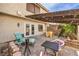 Charming patio with a lounge chair, dining table, and beautiful plants, perfect for outdoor relaxation at 3365 Zephyr Ct, Las Vegas, NV 89121