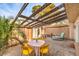 A cozy patio space featuring brick pavers, a wooden pergola, and ample seating for outdoor enjoyment at 3365 Zephyr Ct, Las Vegas, NV 89121