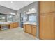 Open bathroom with double vanity, marble countertops, and a shower with a glass door, plus a view to another room at 337 Glenridding St, Las Vegas, NV 89183