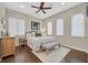 Cozy bedroom with ceiling fan, wood floors, natural light, and comfortable seating at 337 Glenridding St, Las Vegas, NV 89183